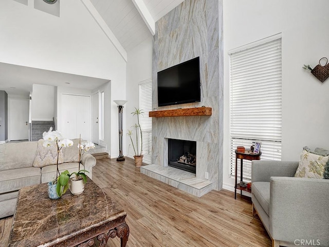 3842 Montego Dr, Huntington Beach, CA 92649 - living room featuring wood finished floors, beam ceiling, a tile fireplace, high vaulted ceiling, and baseboards