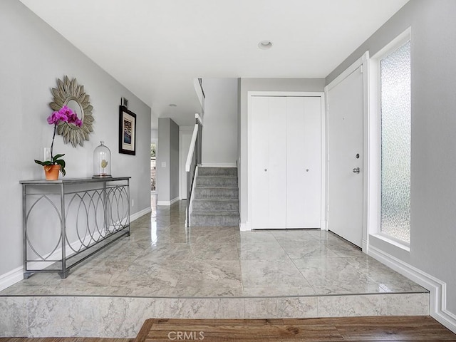 3842 Montego Dr, Huntington Beach, CA 92649 - foyer entrance with marble tiled floors, plenty of natural light, baseboards, and stairs
