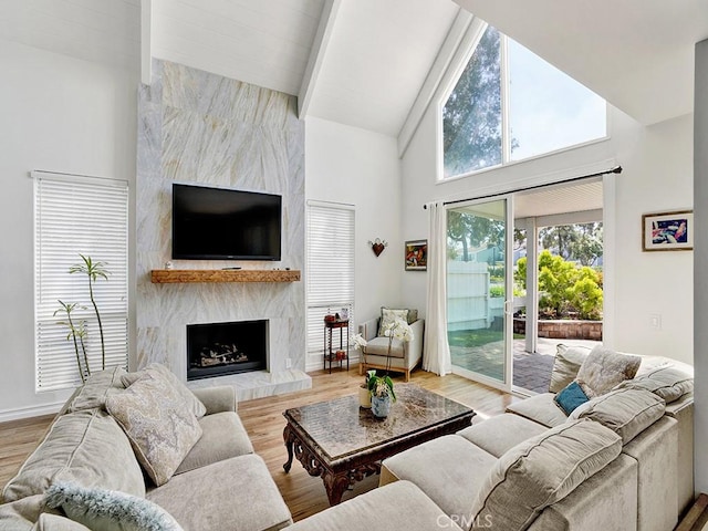 3842 Montego Dr, Huntington Beach, CA 92649 - living area featuring beamed ceiling, a premium fireplace, high vaulted ceiling, light wood finished floors, and baseboards