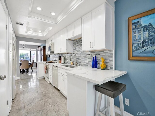 3842 Montego Dr, Huntington Beach, CA 92649 - kitchen with a sink, white microwave, gas stove, decorative backsplash, and ornamental molding