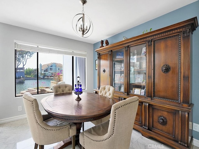 3842 Montego Dr, Huntington Beach, CA 92649 - dining room with a chandelier, baseboards, and light marble finish floors