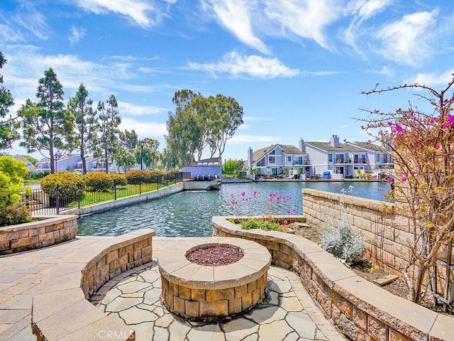 3842 Montego Dr, Huntington Beach, CA 92649 - view of pool featuring an outdoor fire pit, a water view, a patio area, and fence
