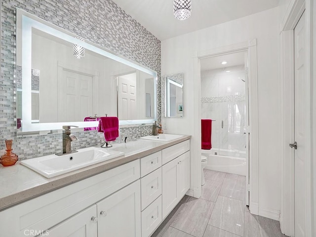 3842 Montego Dr, Huntington Beach, CA 92649 - bathroom with toilet, double vanity, shower / bath combination with glass door, and decorative backsplash