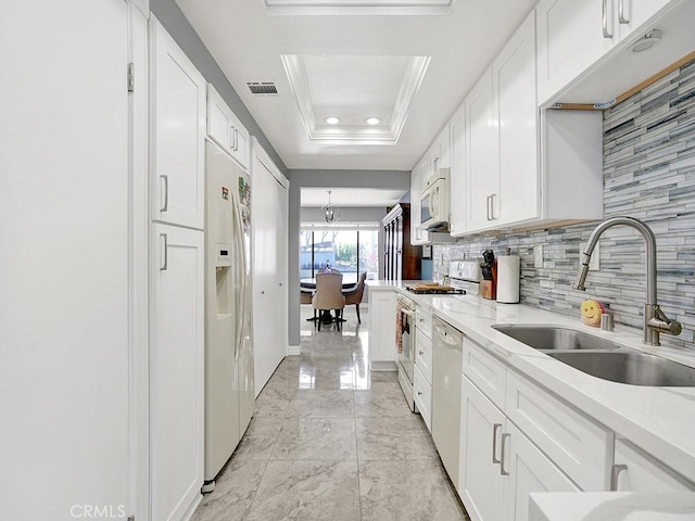 3842 Montego Dr, Huntington Beach, CA 92649 - kitchen featuring a sink, white appliances, light marble finish floors, white cabinets, and backsplash