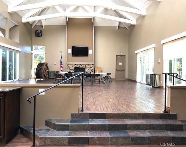 3842 Montego Dr, Huntington Beach, CA 92649 - playroom with high vaulted ceiling, a fireplace, beam ceiling, and wood finished floors