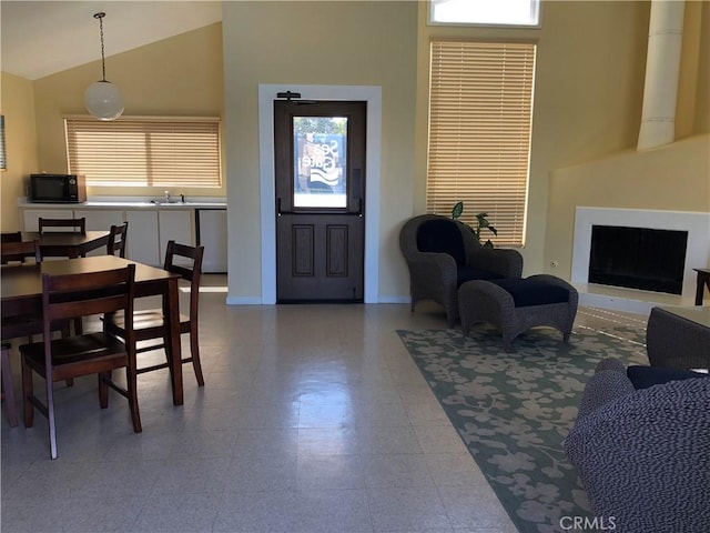 3842 Montego Dr, Huntington Beach, CA 92649 - living room featuring plenty of natural light, a fireplace, high vaulted ceiling, and baseboards