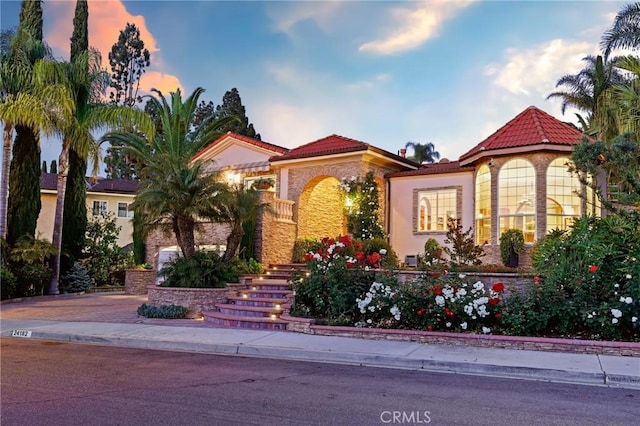 24182 Torena Cir, Mission Viejo, CA 92691 - mediterranean / spanish-style house featuring a tiled roof, stucco siding, and stairway