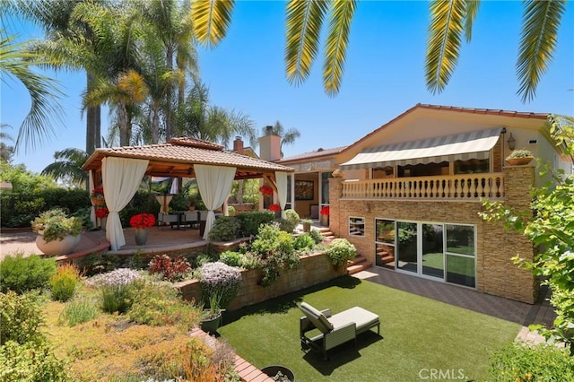 24182 Torena Cir, Mission Viejo, CA 92691 - back of property with a gazebo, a chimney, stone siding, and a patio area