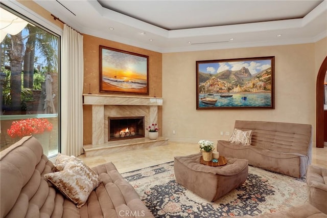 24182 Torena Cir, Mission Viejo, CA 92691 - living area featuring a tray ceiling, a premium fireplace, recessed lighting, arched walkways, and crown molding