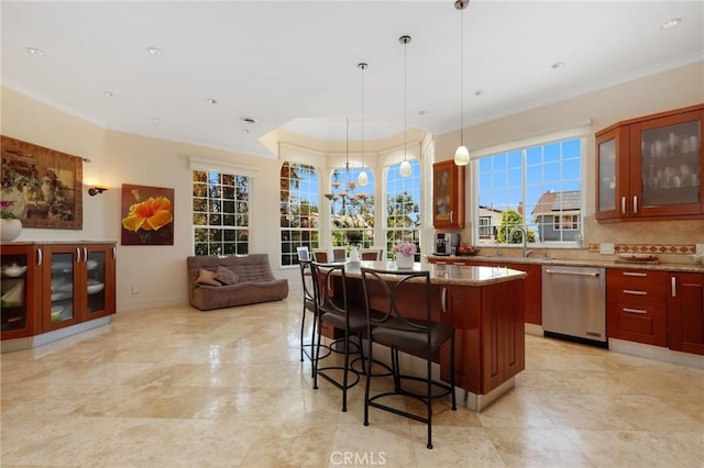 24182 Torena Cir, Mission Viejo, CA 92691 - kitchen with stainless steel dishwasher, a center island, decorative backsplash, plenty of natural light, and ornamental molding