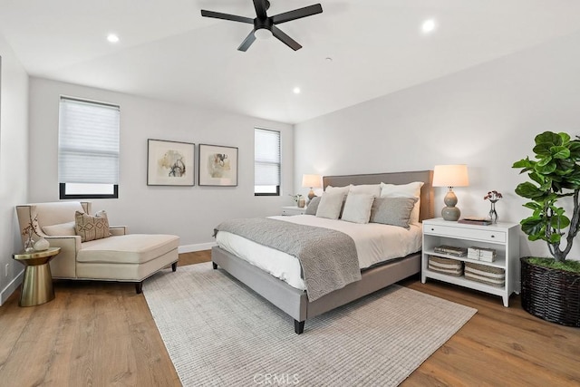 bedroom featuring wood finished floors, recessed lighting, vaulted ceiling, baseboards, and a ceiling fan