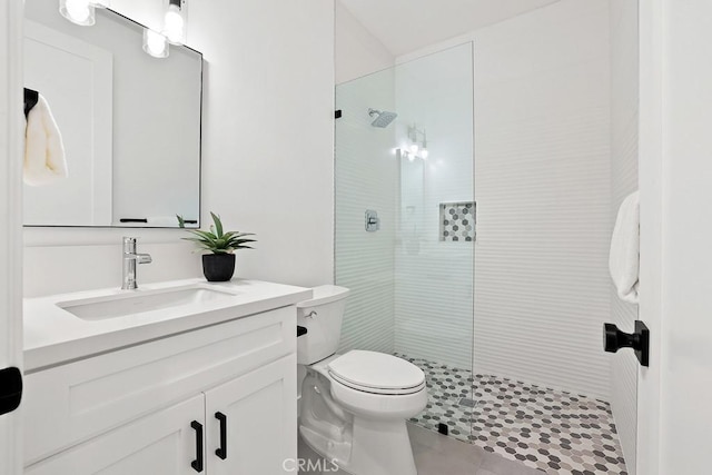 bathroom with walk in shower, toilet, vanity, and tile patterned floors