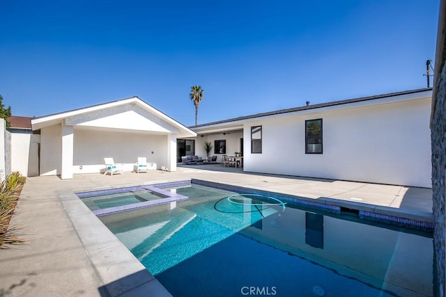 view of swimming pool with a patio area, a pool with connected hot tub, and outdoor lounge area