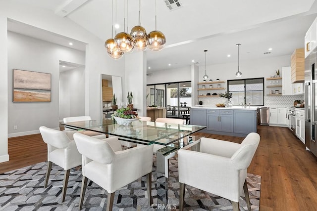 dining space with dark wood finished floors, a chandelier, recessed lighting, and baseboards