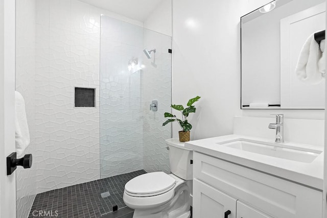 bathroom with toilet, a walk in shower, vanity, and tile patterned flooring