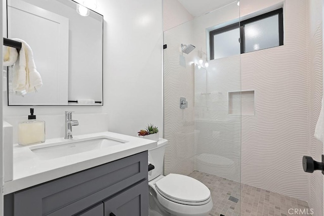 bathroom featuring walk in shower, toilet, and vanity