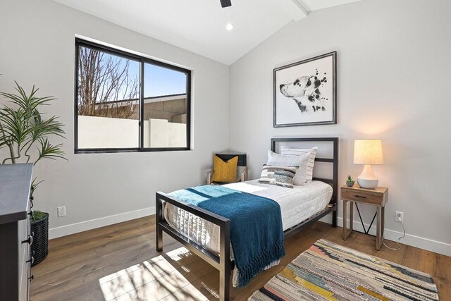 bedroom featuring baseboards, wood finished floors, and a ceiling fan