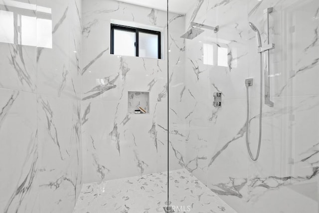 bathroom with a marble finish shower