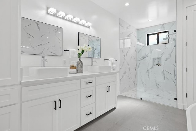 bathroom with a marble finish shower, double vanity, and recessed lighting