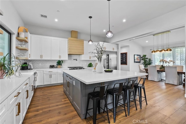 11221 Davenport Rd, Rossmoor, CA 90720 - kitchen featuring high end refrigerator, open shelves, decorative backsplash, white cabinets, and light countertops