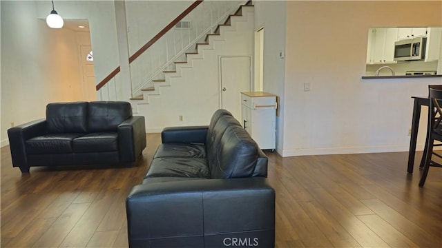 517 Wayland Ct, Claremont, CA 91711 - living area with dark wood-type flooring, stairs, and baseboards