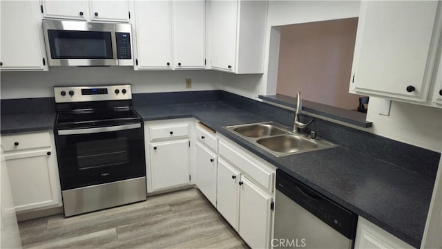 517 Wayland Ct, Claremont, CA 91711 - kitchen featuring appliances with stainless steel finishes, a sink, white cabinets, and light wood-style floors