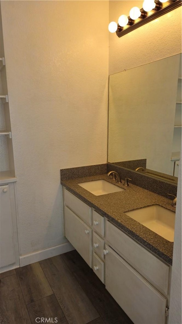 517 Wayland Ct, Claremont, CA 91711 - bathroom featuring wood finished floors, double vanity, and baseboards