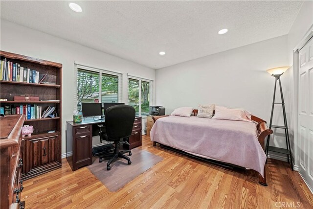 19439 Oak Crossing Rd, Newhall, CA 91321 - bedroom with light wood-type flooring, an office area, recessed lighting, and a textured ceiling