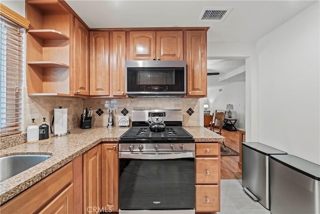 19439 Oak Crossing Rd, Newhall, CA 91321 - kitchen featuring stainless steel appliances, light stone countertops, open shelves, and backsplash