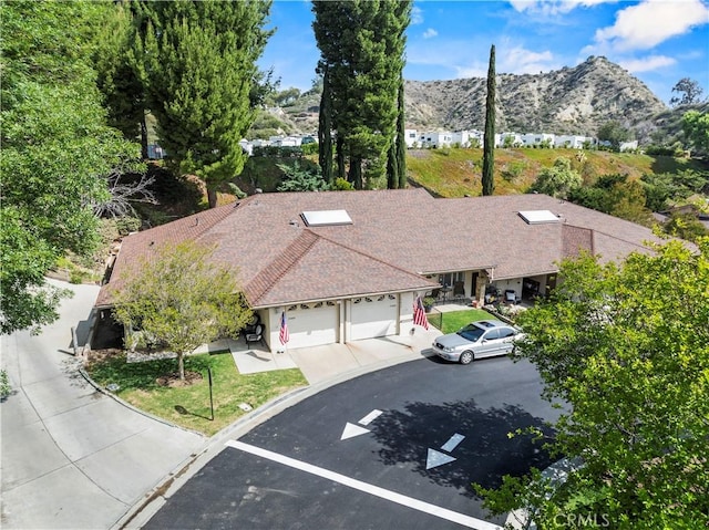 19439 Oak Crossing Rd, Newhall, CA 91321 - view of front of home with a mountain view, an attached garage, and driveway
