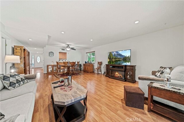 19439 Oak Crossing Rd, Newhall, CA 91321 - living room with light wood-style floors, recessed lighting, ceiling fan, and a glass covered fireplace