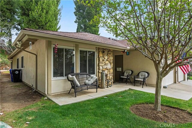 19439 Oak Crossing Rd, Newhall, CA 91321 - back of property featuring a yard, a patio area, and stucco siding