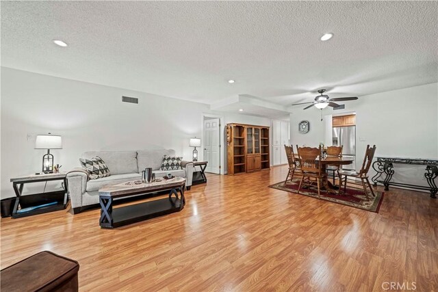 19439 Oak Crossing Rd, Newhall, CA 91321 - living room with a textured ceiling, ceiling fan, light wood-style flooring, and recessed lighting