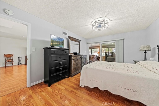 19439 Oak Crossing Rd, Newhall, CA 91321 - bedroom featuring light wood-type flooring and a textured ceiling