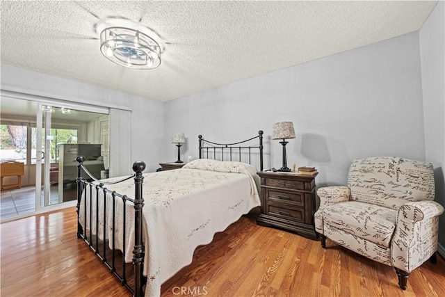 19439 Oak Crossing Rd, Newhall, CA 91321 - bedroom with wood finished floors, a textured ceiling, and access to outside