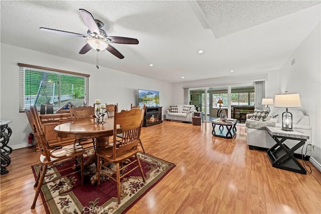 19439 Oak Crossing Rd, Newhall, CA 91321 - dining room featuring light wood-style flooring, ceiling fan, a textured ceiling, and recessed lighting