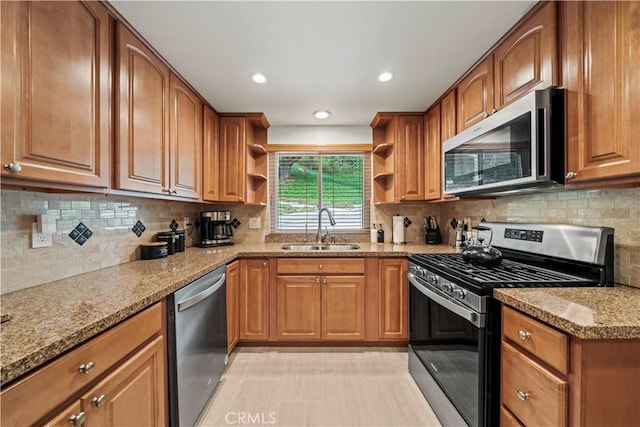 19439 Oak Crossing Rd, Newhall, CA 91321 - kitchen with stainless steel appliances, open shelves, light stone counters, brown cabinets, and recessed lighting