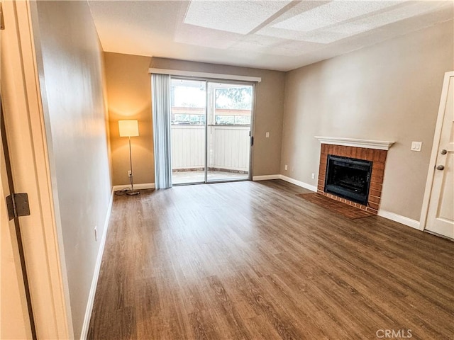 2474 Pleasant Way Unit E, Thousand Oaks, CA 91362 - unfurnished living room featuring dark wood-style floors and a fireplace