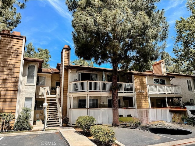 2474 Pleasant Way Unit E, Thousand Oaks, CA 91362 - view of building exterior featuring stairway and uncovered parking