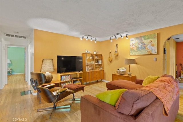 297 Connors Ave, Chico, CA 95926 - living area with arched walkways, wood finished floors, baseboards, and rail lighting
