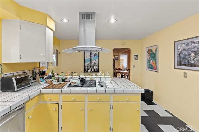 297 Connors Ave, Chico, CA 95926 - kitchen with island exhaust hood, a peninsula, tile countertops, arched walkways, and recessed lighting