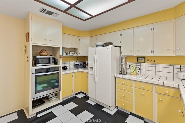 297 Connors Ave, Chico, CA 95926 - kitchen with appliances with stainless steel finishes, tile counters, and open shelves