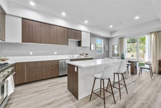 689 Castlehill Dr, Walnut, CA 91789 - kitchen featuring stainless steel appliances, a kitchen island, a breakfast bar area, light wood-style flooring, and recessed lighting