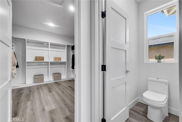 689 Castlehill Dr, Walnut, CA 91789 - bathroom featuring wood finished floors, toilet, and baseboards