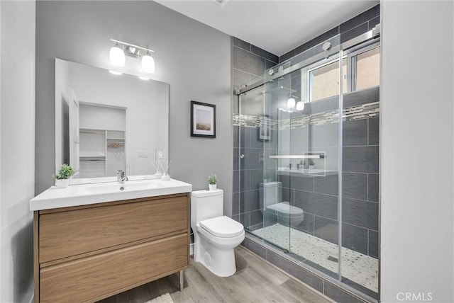 689 Castlehill Dr, Walnut, CA 91789 - full bathroom with toilet, wood finished floors, a stall shower, and vanity