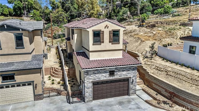 689 Castlehill Dr, Walnut, CA 91789 - mediterranean / spanish house featuring a garage, fence, stone siding, stucco siding, and concrete driveway