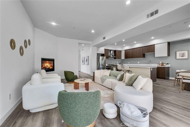 689 Castlehill Dr, Walnut, CA 91789 - living room featuring light wood-style floors, baseboards, recessed lighting, and a glass covered fireplace