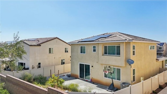 36927 Arezzo Ct, Beaumont, CA 92223 - back of house with stucco siding, solar panels, central air condition unit, and a fenced backyard