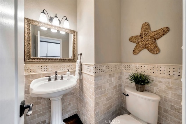 417 Via Presa, San Clemente, CA 92672 - half bathroom with tile walls, a wainscoted wall, and toilet