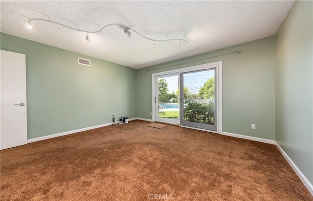 645 Alta Loma Dr, Redlands, CA 92373 - carpeted spare room with rail lighting, baseboards, and a textured ceiling